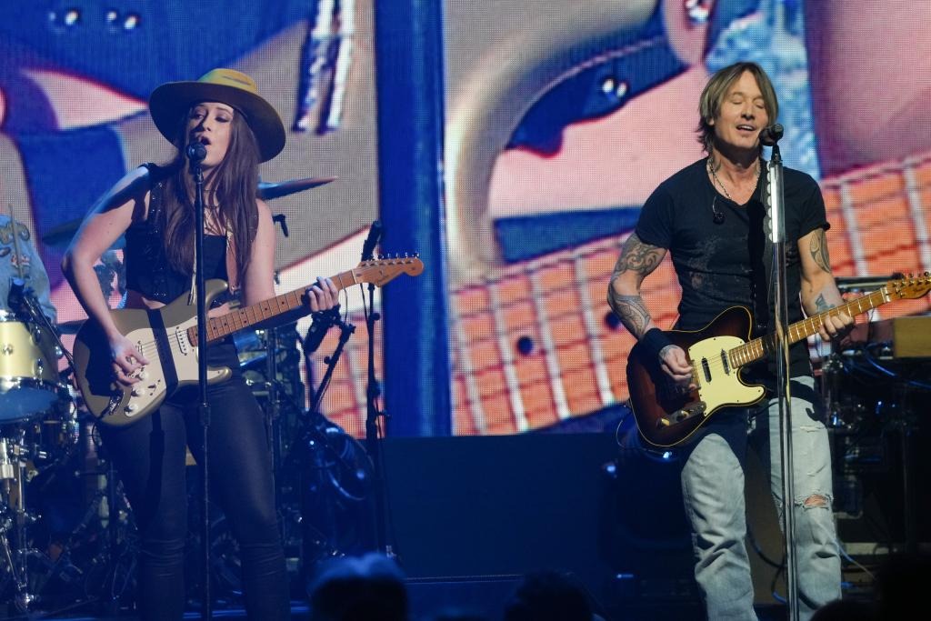 Maggie Baugh and Keith Urban perform during the iHeartCountry Festival.Getty Images