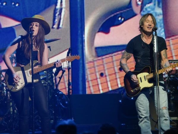 Maggie Baugh and Keith Urban perform during the iHeartCountry Festival. Getty Images